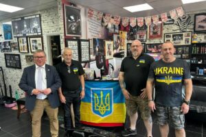 Four men supporting Ukraine with flag.