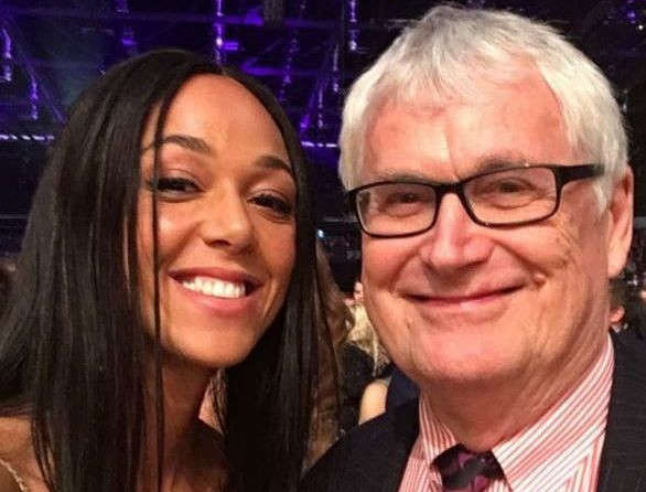 Woman and man smiling together at event.